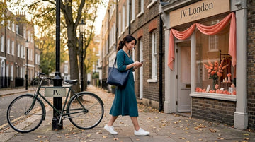 Woman in teal midi dress crossing city street