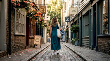 Woman in teal maxi dress walking city sidewalk