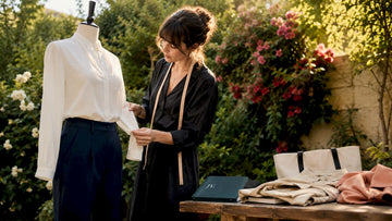 Stylist adjusting blouse on mannequin