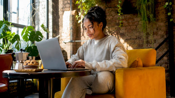 Woman browsing UK fashion deals on laptop