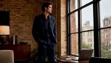 Man wearing relaxed tailored navy blue suit