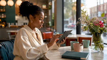 Woman browsing fashion haul on tablet at home