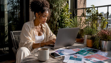 Woman tracking fashion discounts on laptop at home