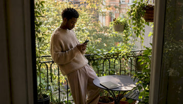 Man wearing oversized sweater in loft interior