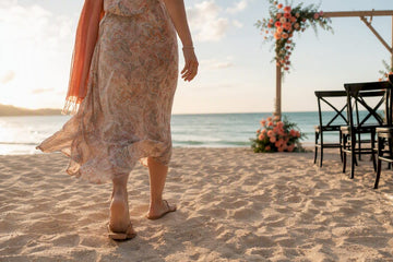 Guest walking across sand at beach wedding