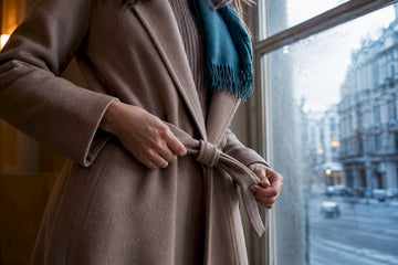 Woman layering a winter dress with coat