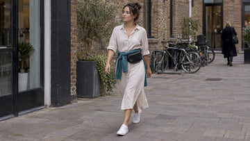 Woman wearing midi dress with white sneakers